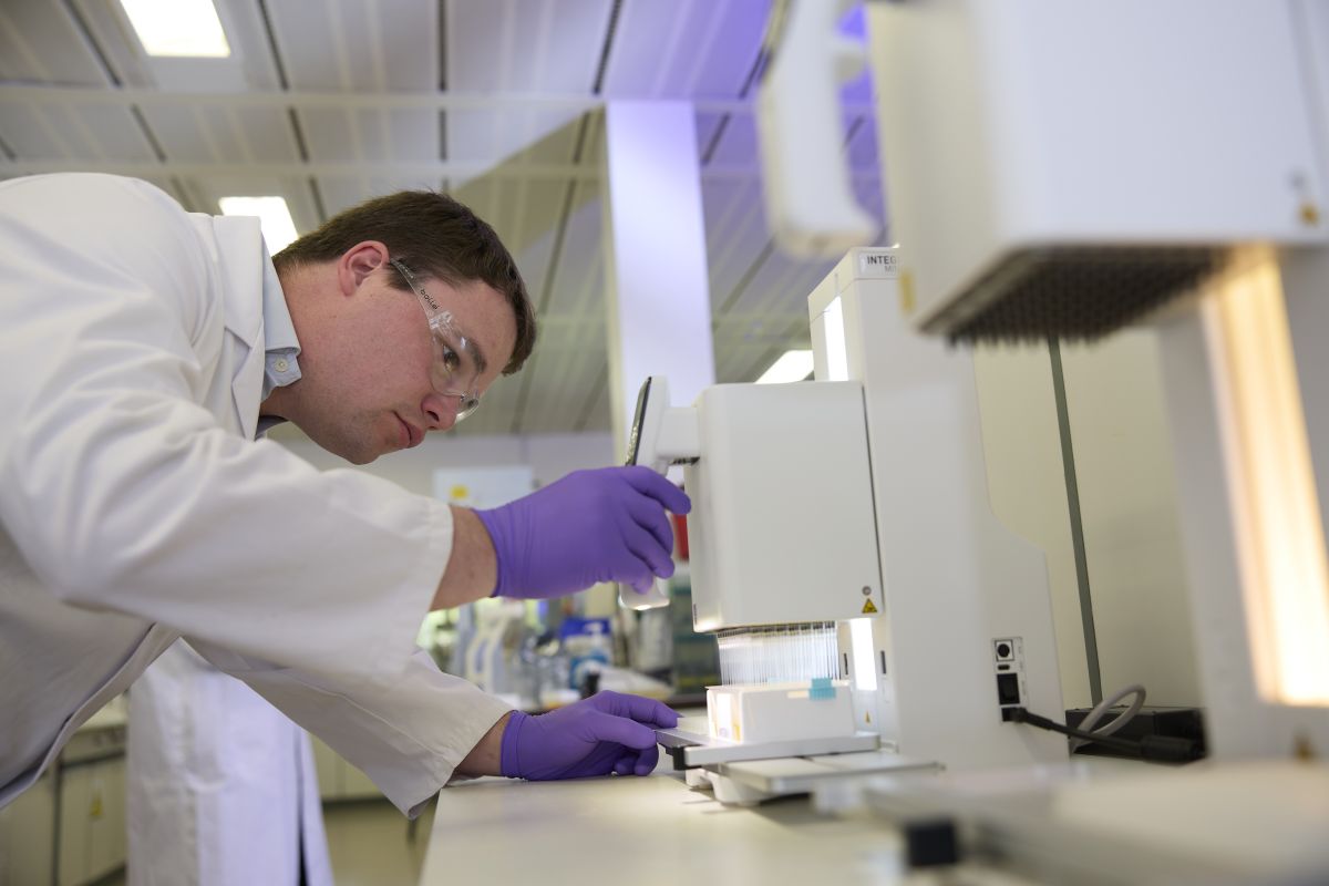 Scientist working on multi-well plate and pipette